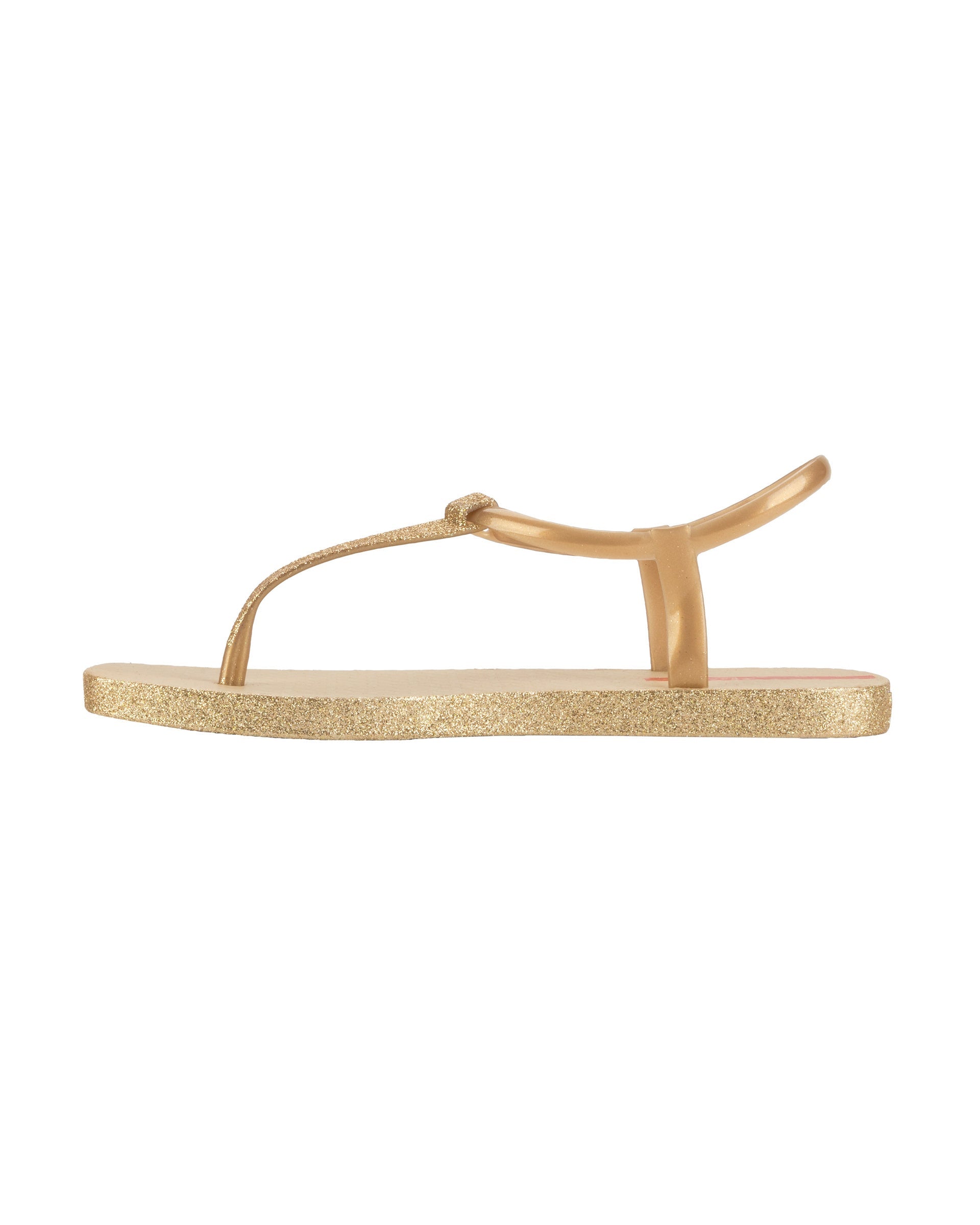 Inner side view of a beige Ipanema Class Edge Glow t-strap women's sandal with glitter black thong.